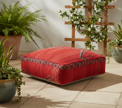 view of vintage Moroccan kilim pouf red tribal in indoor patio