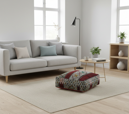 view of vintage Moroccan kilim pouf burgundy multi in contemporary living room