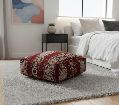 view of vintage Moroccan kilim pouf deep burgundy geometric in scandinavian bedroom