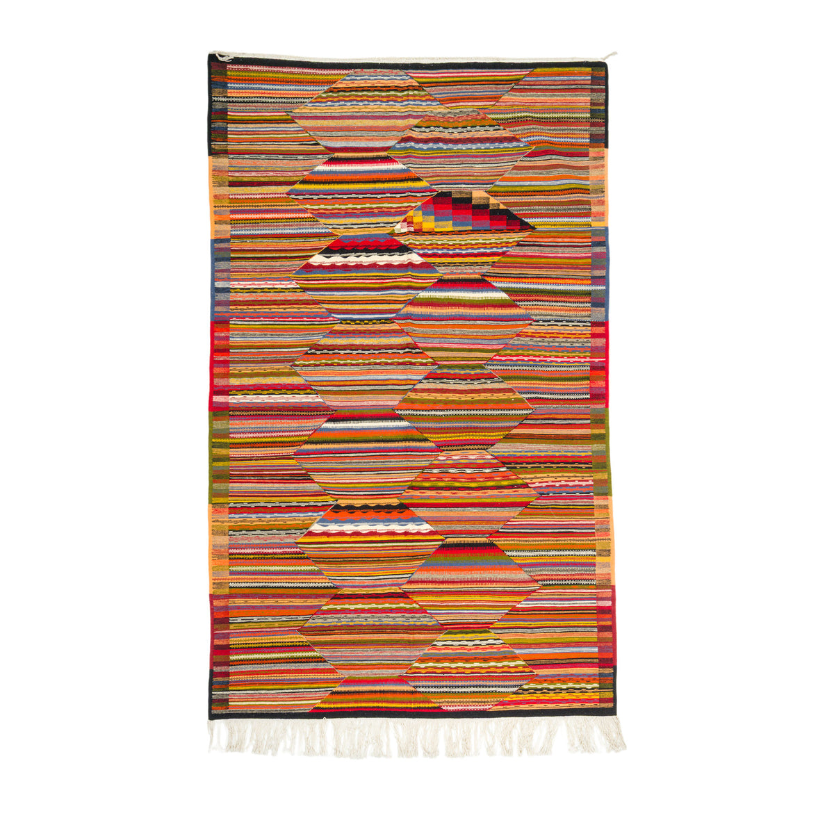 A rectangular woven rug with a geometric pattern made of horizontal striped bands in many colors, finished with white fringe on the bottom edge, shown against a plain white background.
