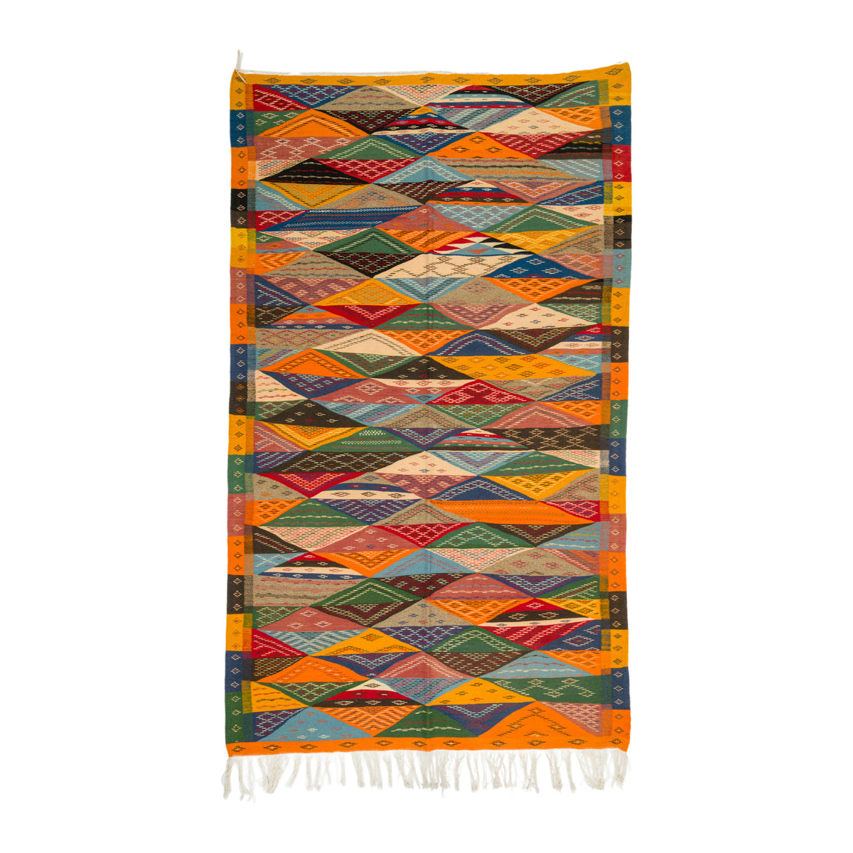 A colorful geometric woven moroccan rug with a diamond pattern, featuring orange borders and white fringe at the bottom, shown against a plain white background.