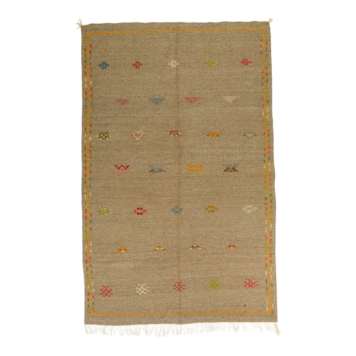 A rectangular woven Akhnif moroccan wool rug in a natural beige color, decorated with small multicolored hand embroidered geometric and floral motifs and finished with white fringe on the bottom edge, shown flat against a white background.