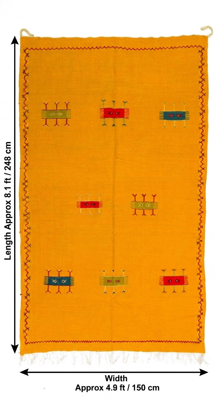 A bright yellow moroccan rug with small multicolor geometric motifs and a decorative border, shown with dimension arrows and text indicating approximately 8.1 ft by 4.
