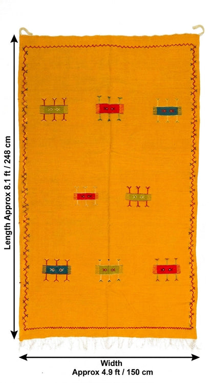 A bright yellow moroccan rug with small multicolor geometric motifs and a decorative border, shown with dimension arrows and text indicating approximately 8.1 ft by 4.