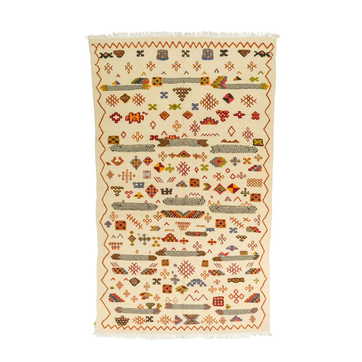 A rectangular handwoven kilim rug with a cream background and intricate multicolor geometric patterns, featuring fringed edges.