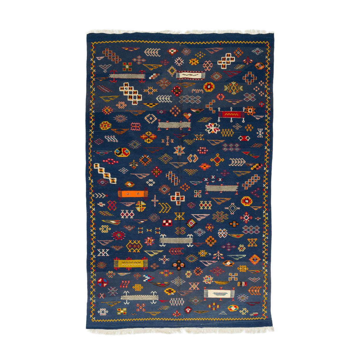 A rectangular dark blue wool rug with intricate multicolor geometric patterns and white fringe on the top and bottom, shown flat against a white background. The beautiful rug is moroccan.