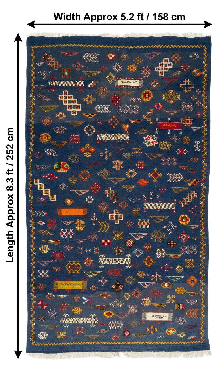 A flat-lay view of a rectangular woven rug with dimension arrows. 