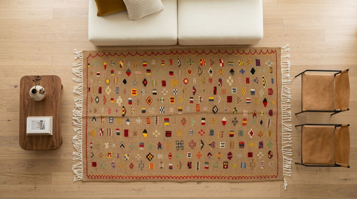 A rectangular area rug with a beige base and a colorful geometric tribal pattern, styled in a modern living room setting on a light wood floor.