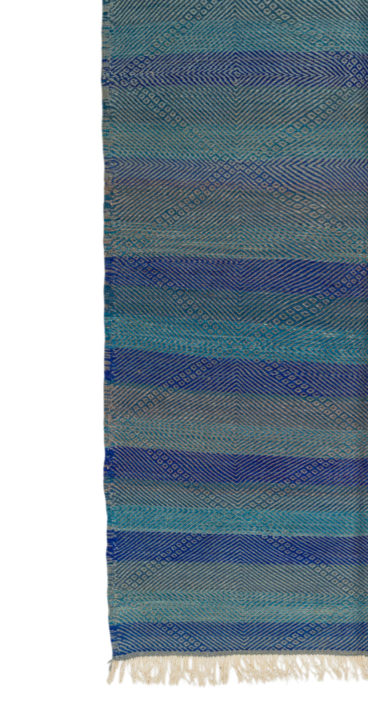 A close-up of aZanafi rug with horizontal stripes in shades of blue, teal, and gray, featuring a textured diamond pattern and off-white fringe at the bottom.