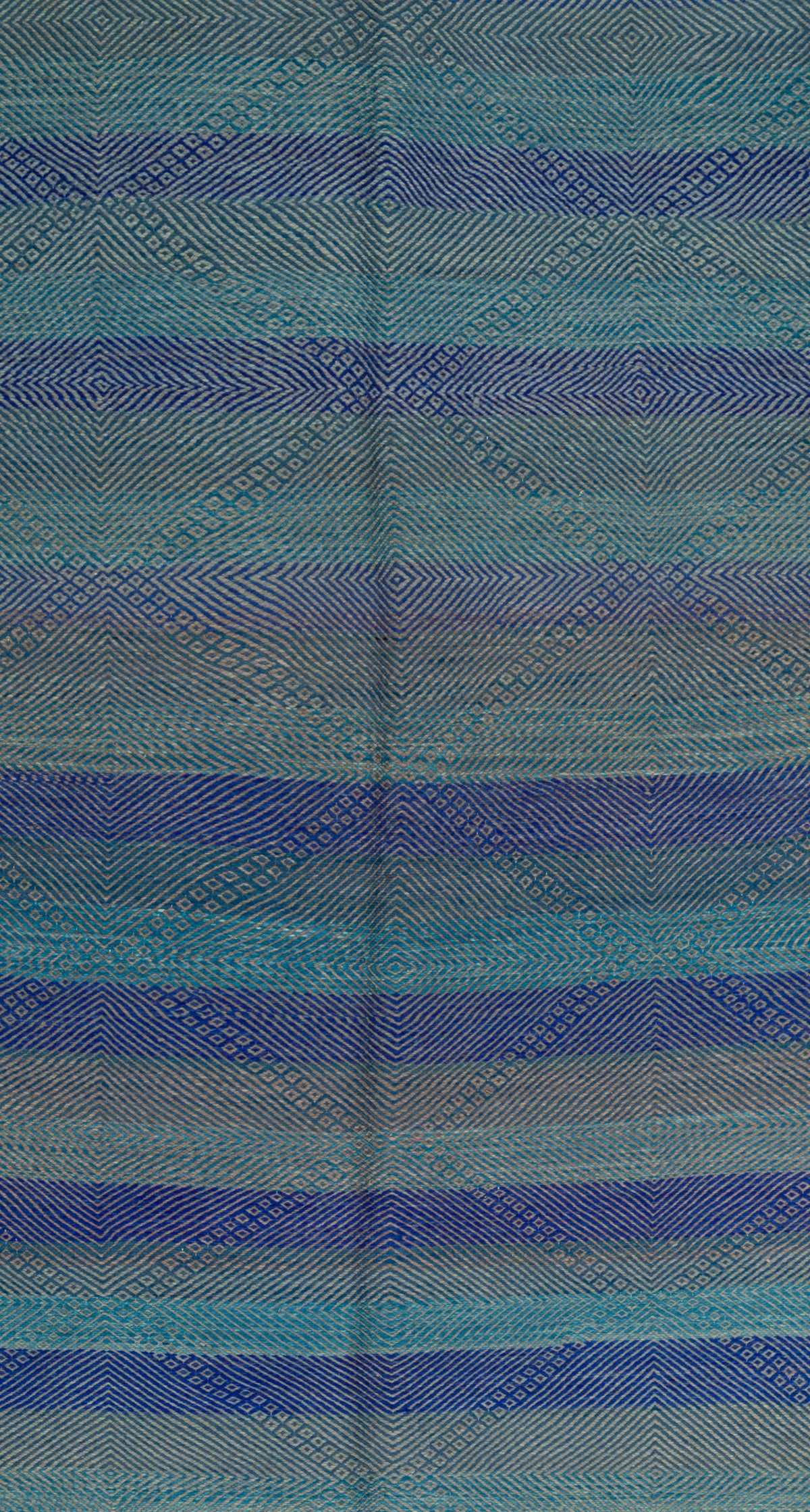 A close-up of a Moroccan Zanafi Rug with horizontal stripes in shades of blue, teal, and gray, featuring a subtle diamond pattern.