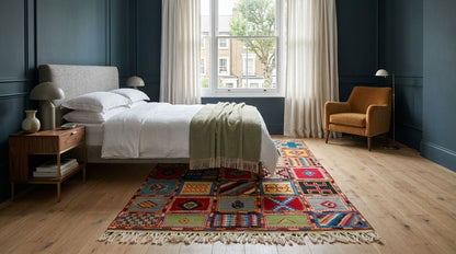 A colourful Moroccan wool rug in a bedroom.