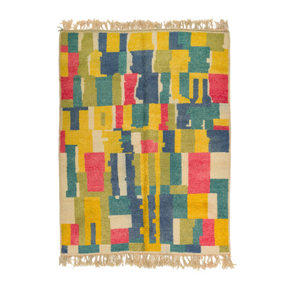 A modern wool high pile woven area rug with a colorful geometric block pattern in yellow, teal, navy, red, and beige, finished with natural beige fringes on the top and bottom. A superb moroccan rug.