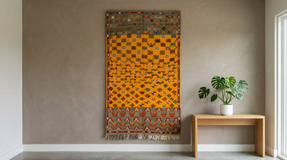 Moroccan wool rug used as a tapestry on a wall.