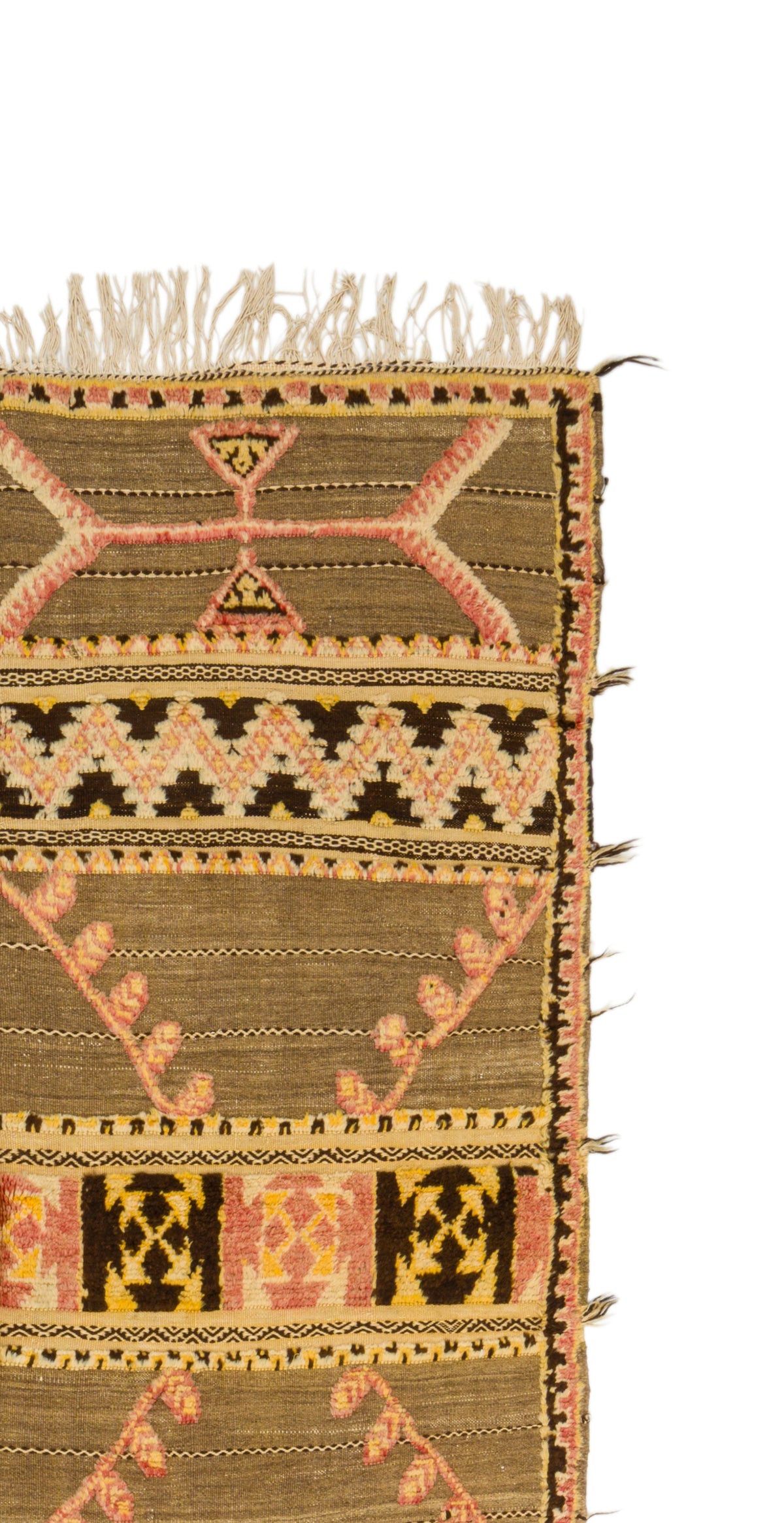 A close-up of a woven Moroccan  rug corner showing a geometric pattern in olive brown, black, pink, and beige with fringed edges on a white background.