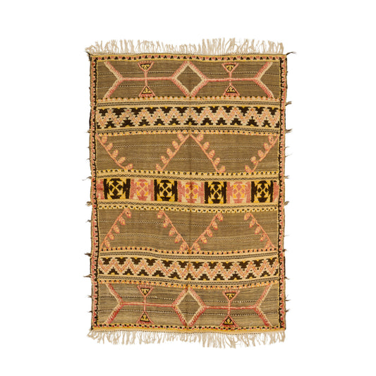 Vintage Moroccan kilim rug with a geometric tribal pattern in beige, brown, pink, and black, featuring fringed edges on a white background.
