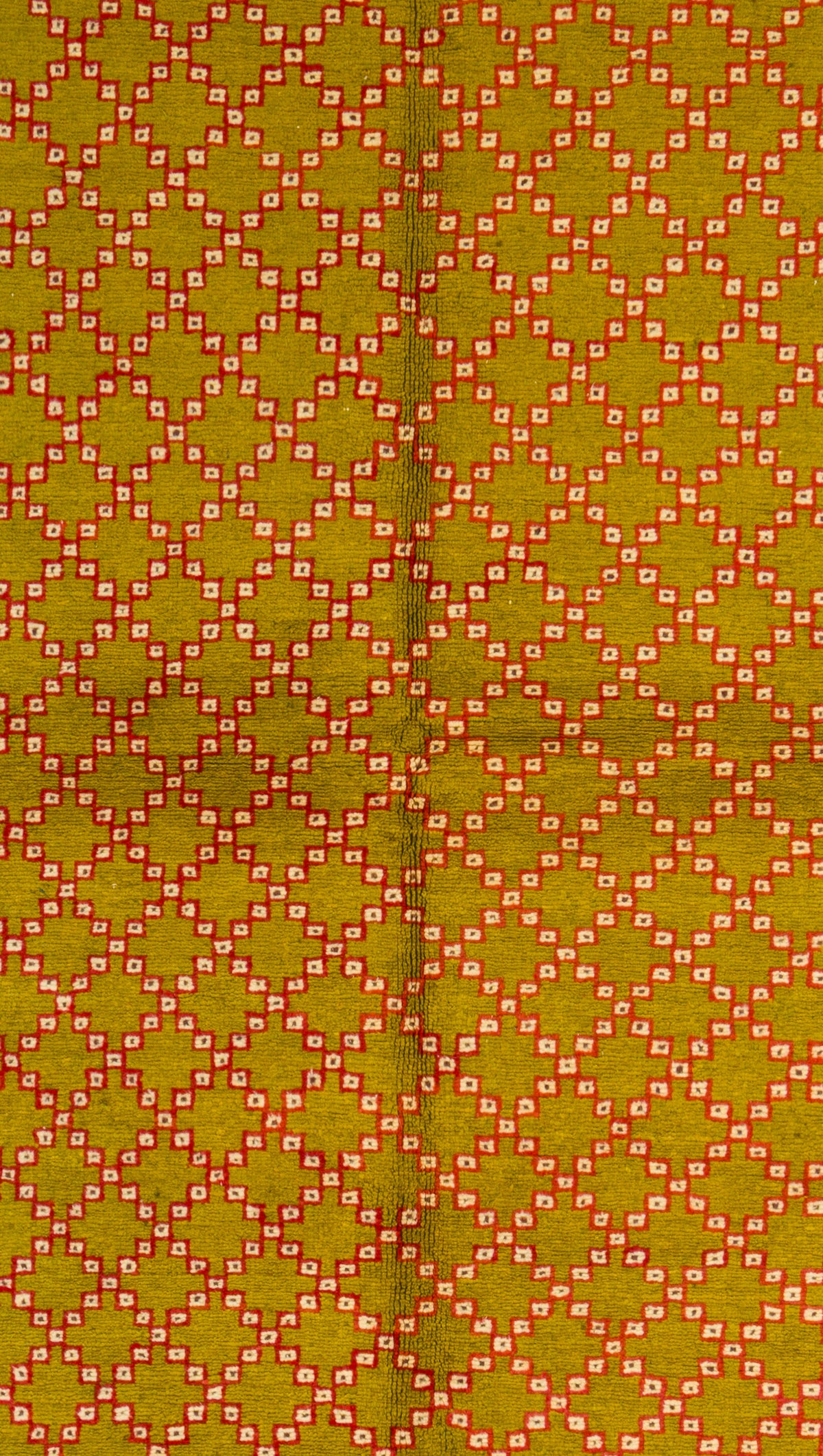 A close-up of a vintage Moroccan rug featuring a repeating geometric diamond lattice design in olive green, orange, and white.