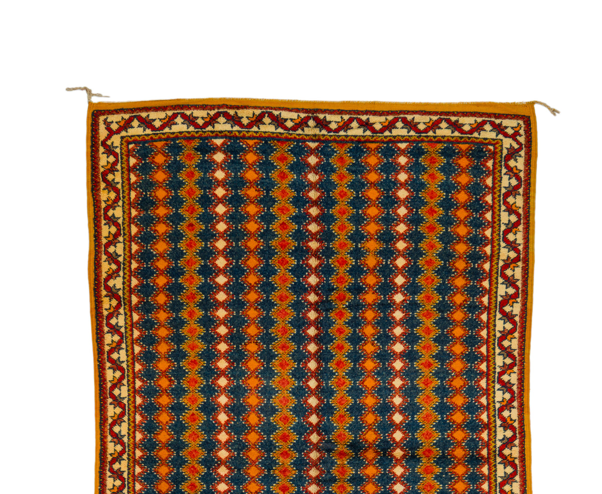 A Taznakht patterned rug shown flat against a white background, featuring vertical stripes of navy blue, orange, and cream geometric motifs with a decorative border.