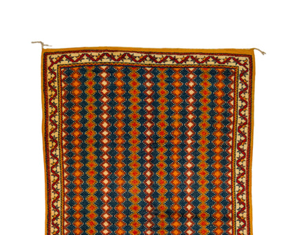 A Taznakht patterned rug shown flat against a white background, featuring vertical stripes of navy blue, orange, and cream geometric motifs with a decorative border.