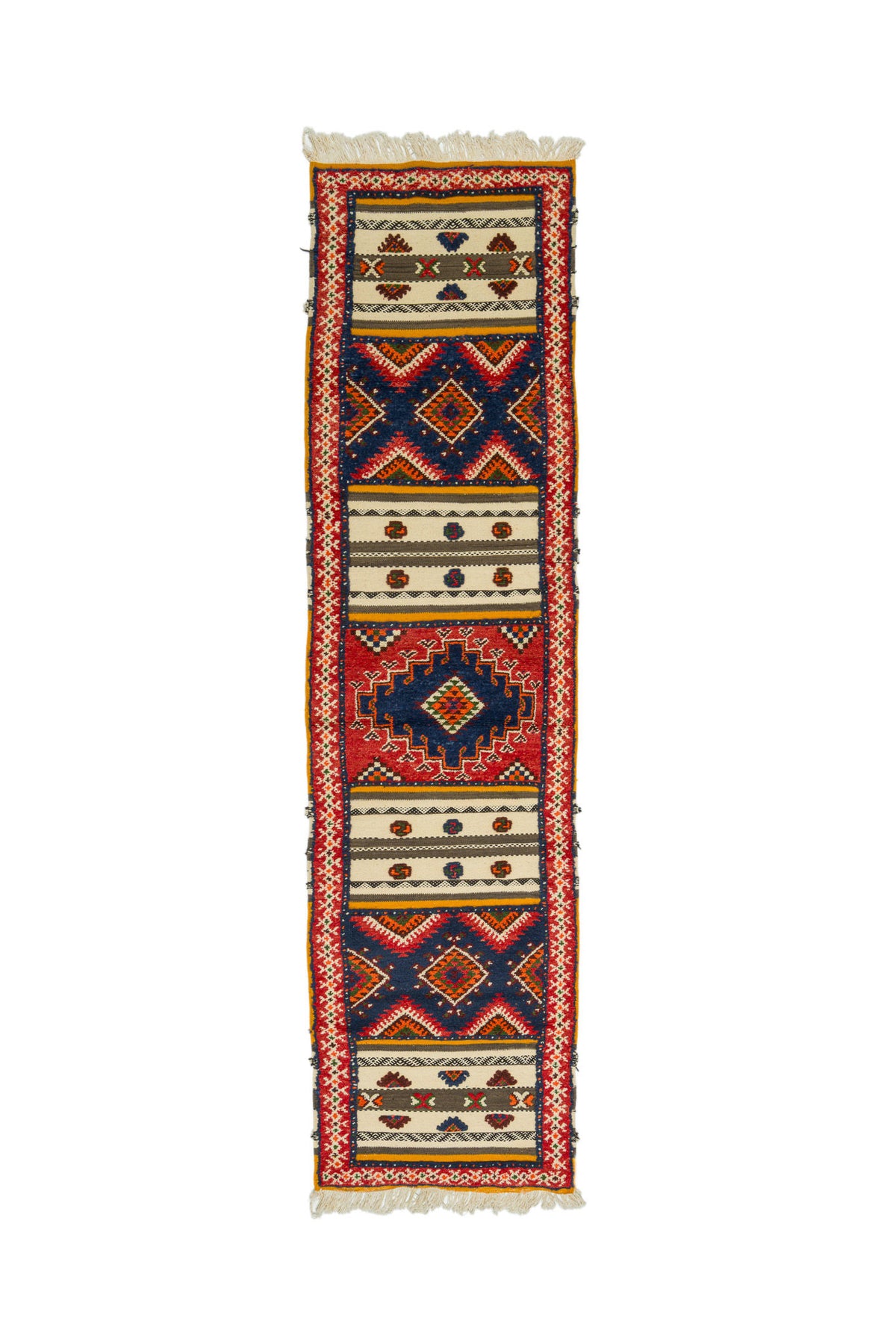 A long, narrow geometric runner rug with fringe on both ends, featuring a bold pattern of red, navy blue, beige, and black.