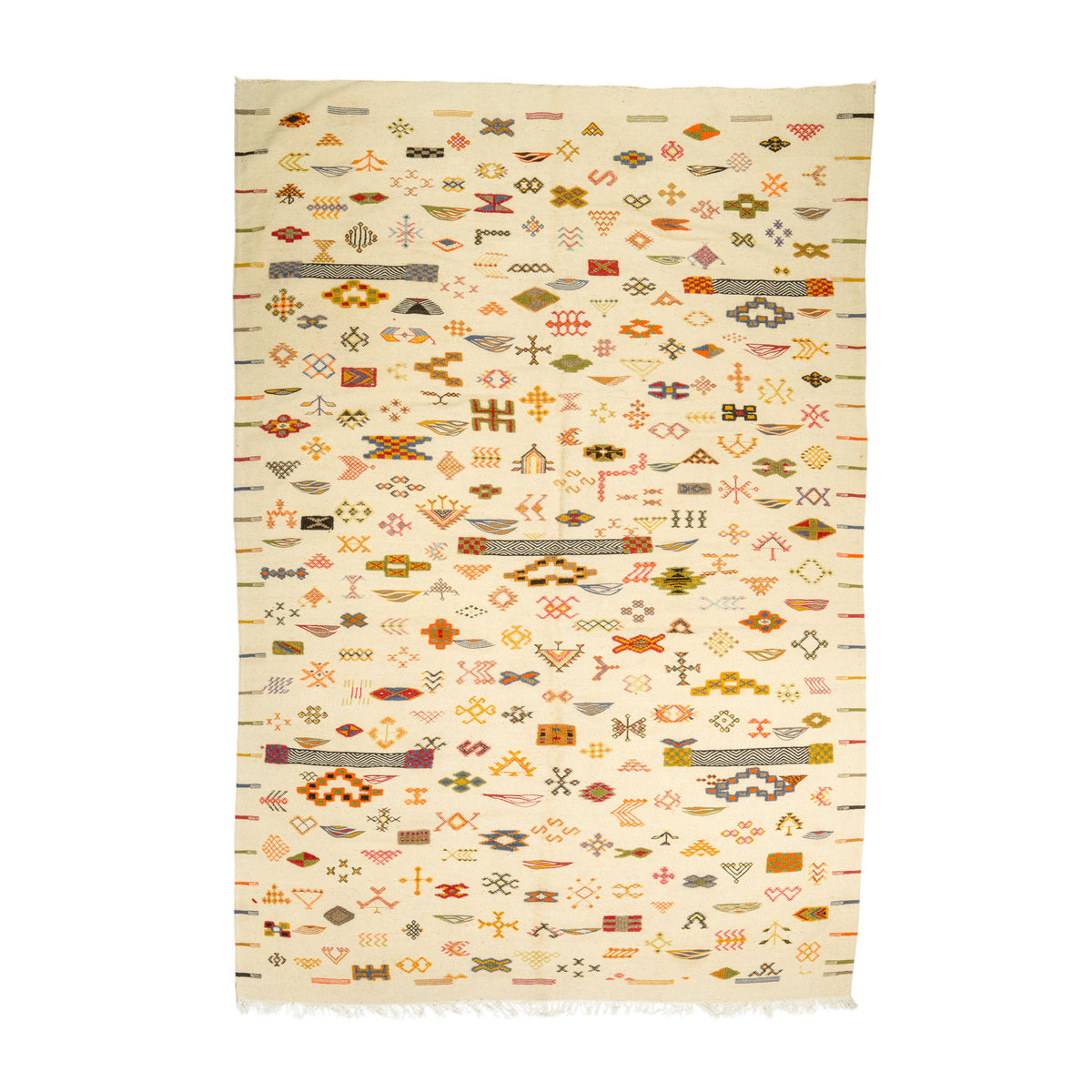 A Moroccan flat weave kilim rug with a cream background and dense geometric patterns in orange, brown, olive green, and pink, finished with short fringe on the bottom edge.