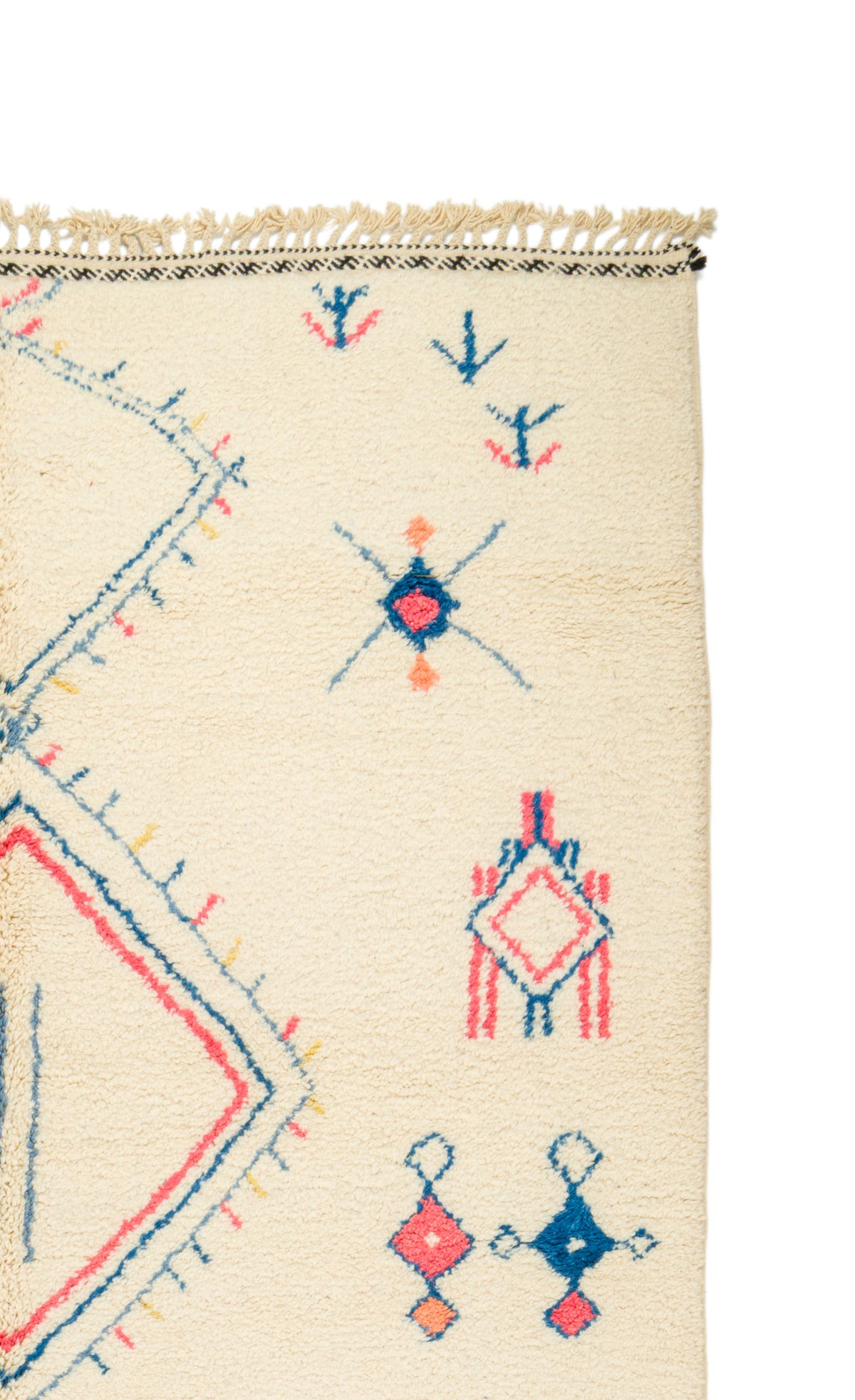 Close-up of a cream-colored  rug with a Southwestern geometric pattern in blue, red, and orange, featuring a fringed edge.