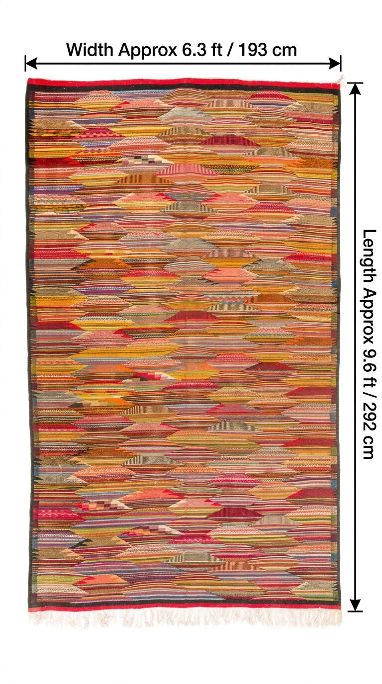 A multicolor woven area rug from taznakht with a geometric cubist, layered pattern of horizontal and diagonal textile strips in red, orange, yellow, beige, and brown tones. The rug is shown with black dimension lines and text overlays indicating its width is approximately 6.