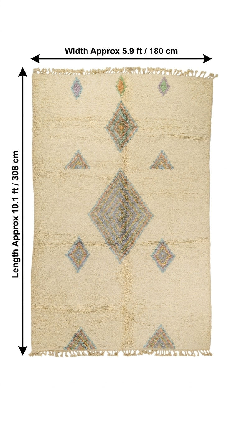 A rectangular woven rug with a cream base and geometric diamond and triangle motifs in muted gray, beige, and soft blue, shown with dimension arrows. A moroccan shag rug.