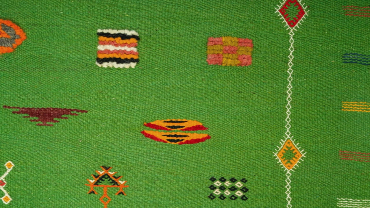 video cloe-up of a green moroccan rug