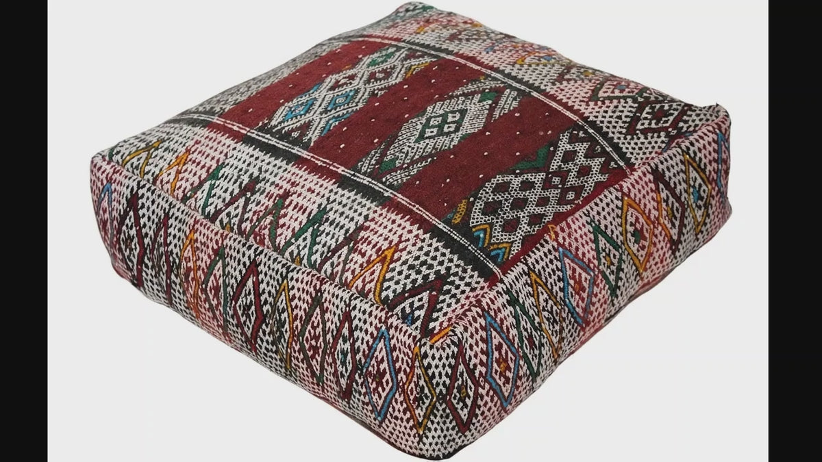 Video of vintage Moroccan kilim pouf  deep red tribal showing texture and Berber details 