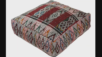 Video of vintage Moroccan kilim pouf  deep red tribal showing texture and Berber details 