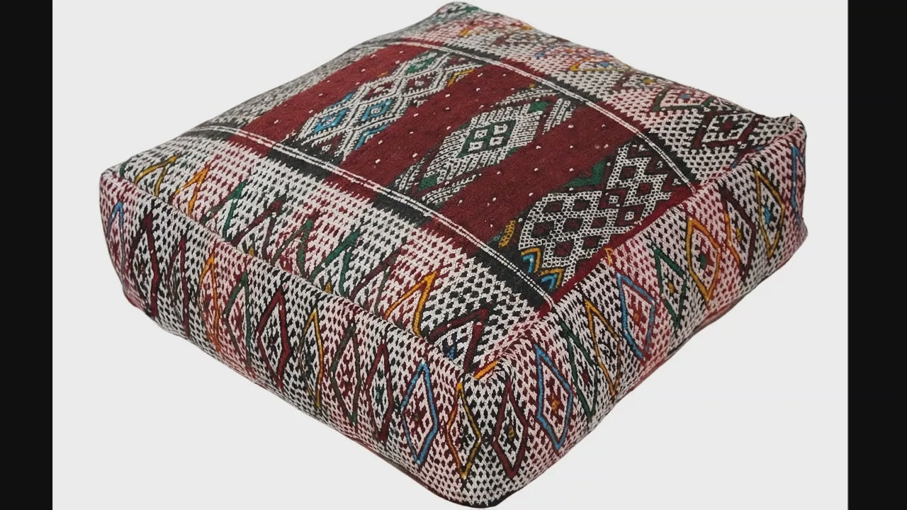 Video of vintage Moroccan kilim pouf  deep red tribal showing texture and Berber details 