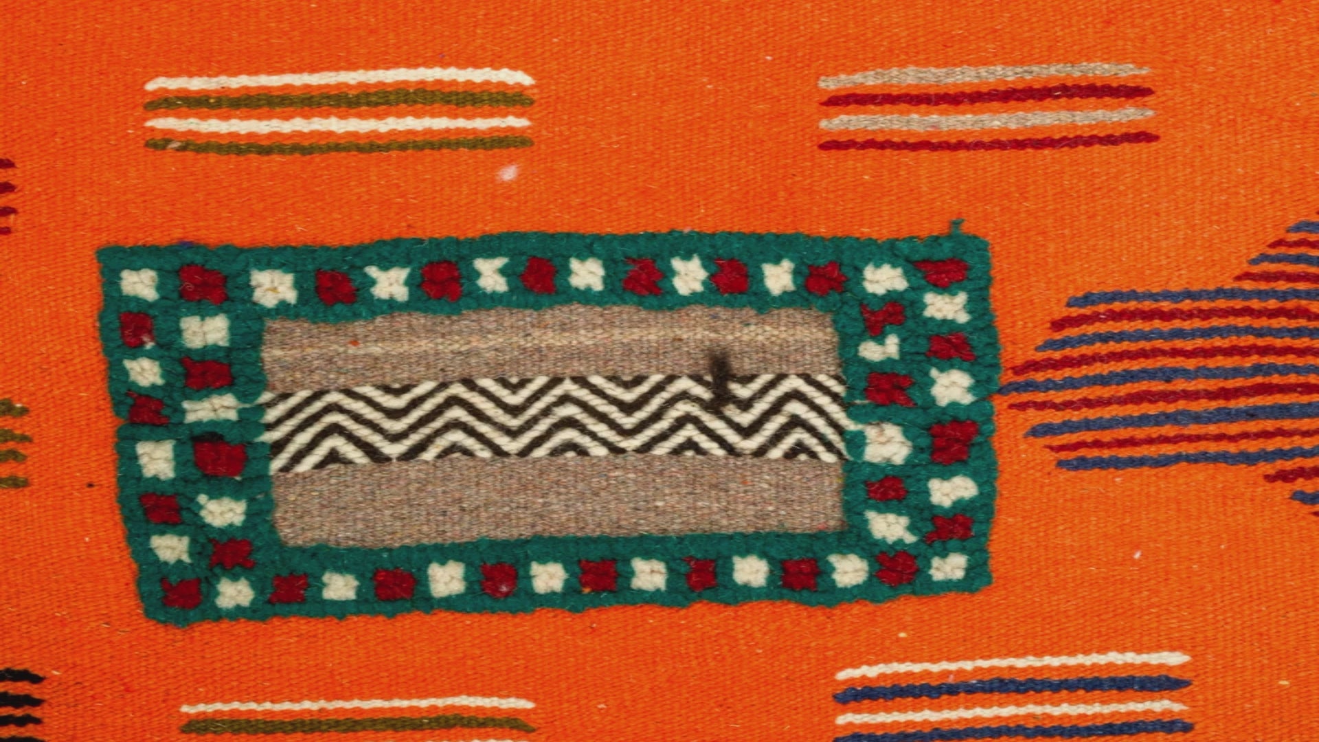 video close-up detail of a moroccan hand embroidered rug.