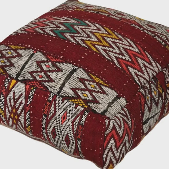 Video of vintage Moroccan kilim pouf burgundy geometric showing texture and Berber details 