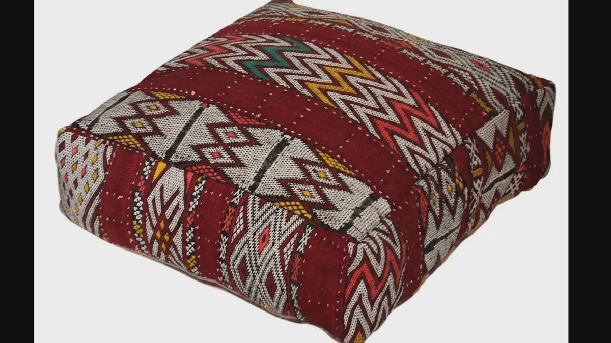 Video of vintage Moroccan kilim pouf burgundy geometric showing texture and Berber details 