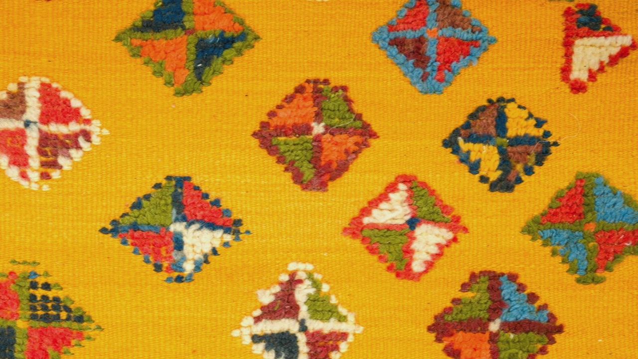 video close-up of a yellow moroccan rug