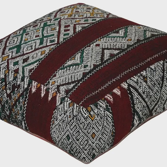 Video of vintage Moroccan kilim pouf deep red tribal showing texture and Berber details 