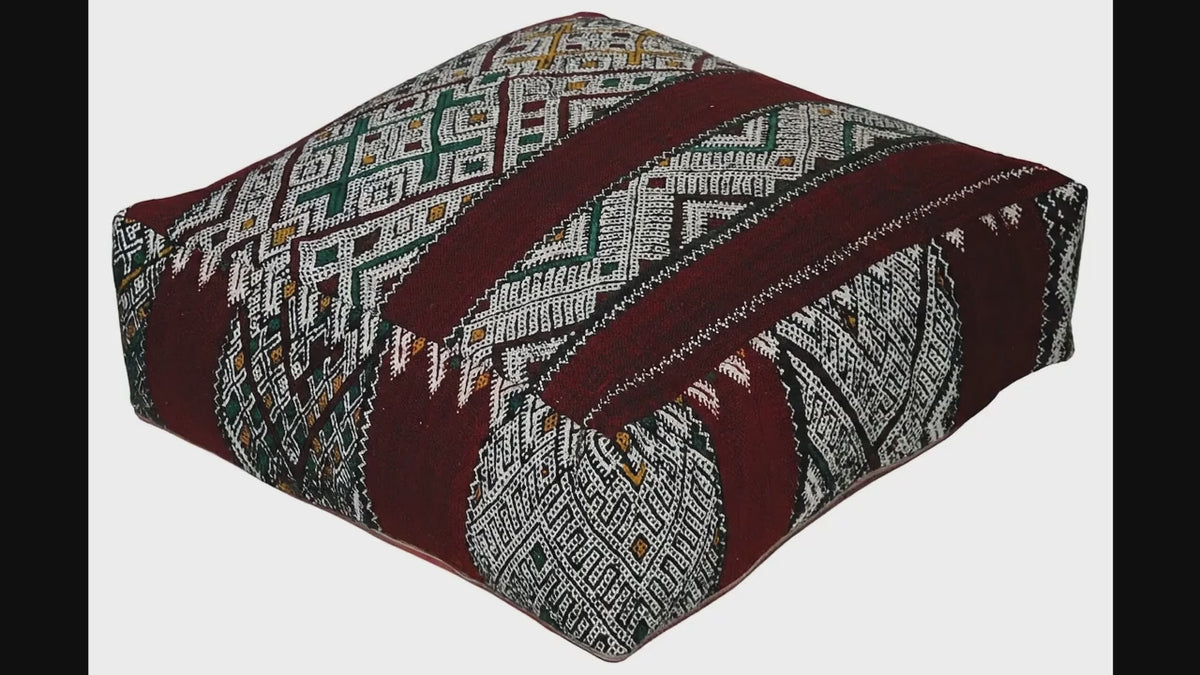 Video of vintage Moroccan kilim pouf deep red tribal showing texture and Berber details 