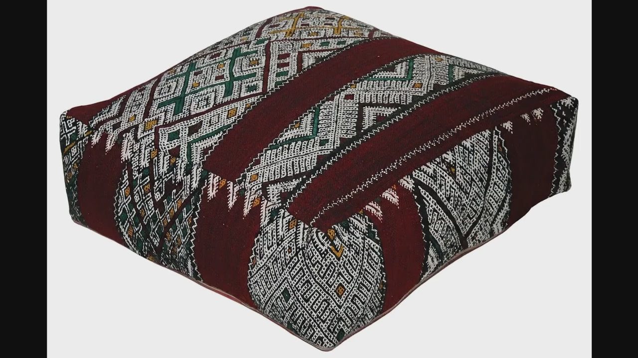Video of vintage Moroccan kilim pouf deep red tribal showing texture and Berber details 