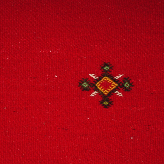 close-up video of moroccan rug red handwoven with hand embroidered tribal motifs