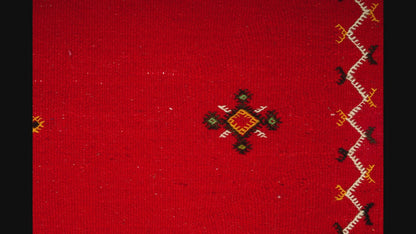 close-up video of moroccan rug red handwoven with hand embroidered tribal motifs
