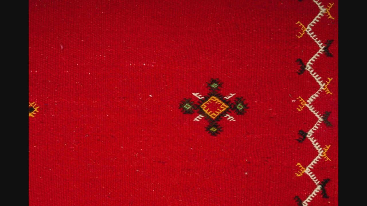 close-up video of moroccan rug red handwoven with hand embroidered tribal motifs