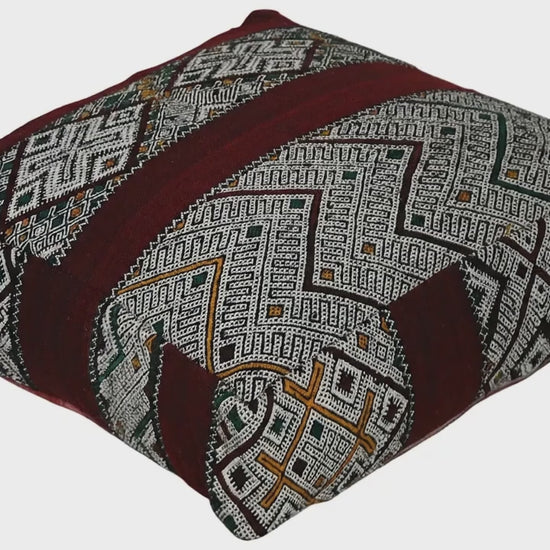 Video of vintage Moroccan kilim pouf deep red tribal showing texture and Berber details 