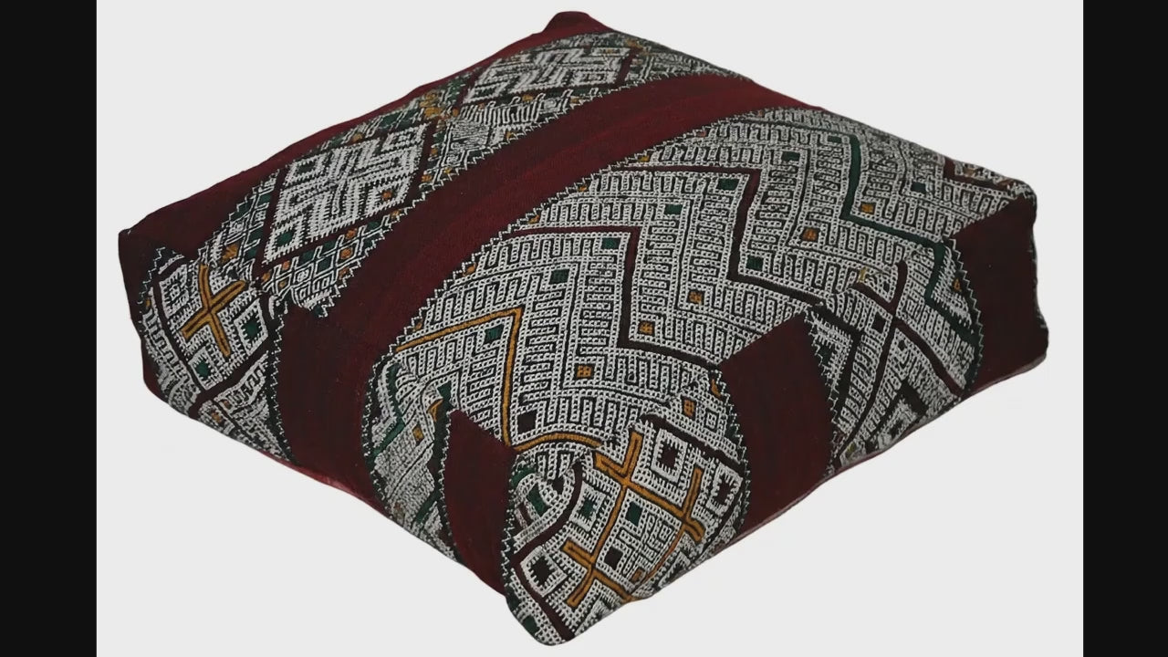 Video of vintage Moroccan kilim pouf deep red tribal showing texture and Berber details 