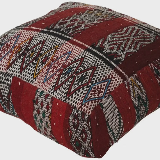 Video of vintage Moroccan kilim pouf  deep red tribal showing texture and Berber details 