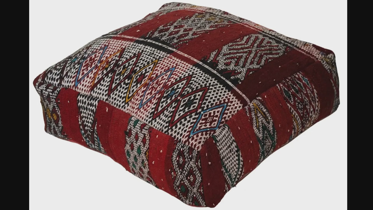 Video of vintage Moroccan kilim pouf  deep red tribal showing texture and Berber details 