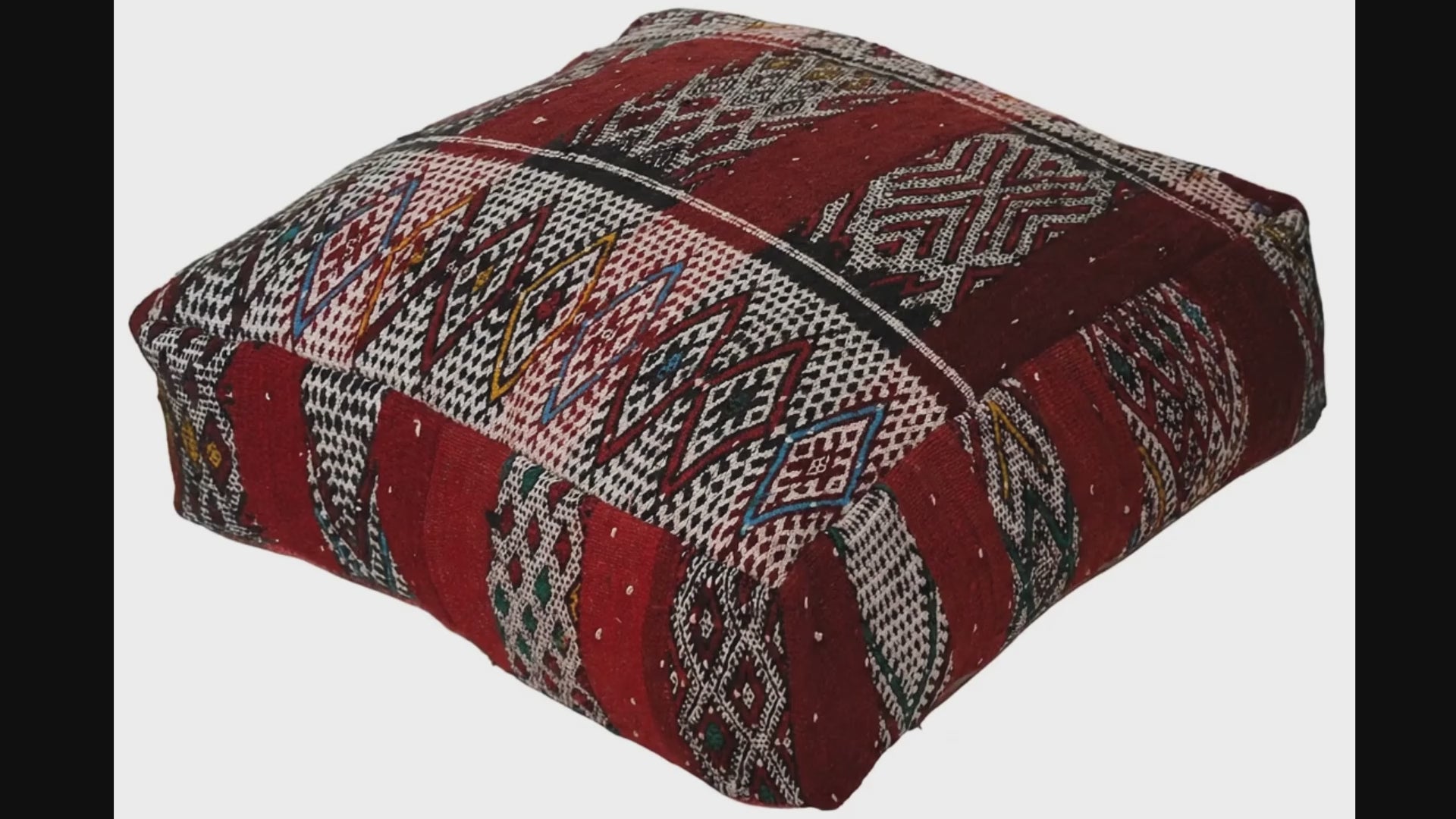 Video of vintage Moroccan kilim pouf  deep red tribal showing texture and Berber details 