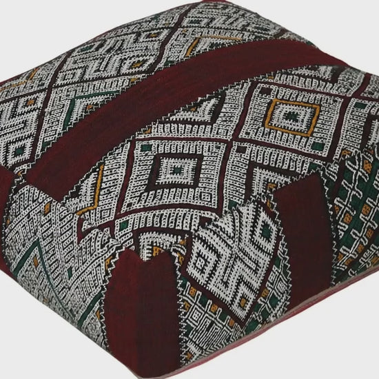 Video of vintage Moroccan kilim pouf burgundy multi showing texture and Berber details 