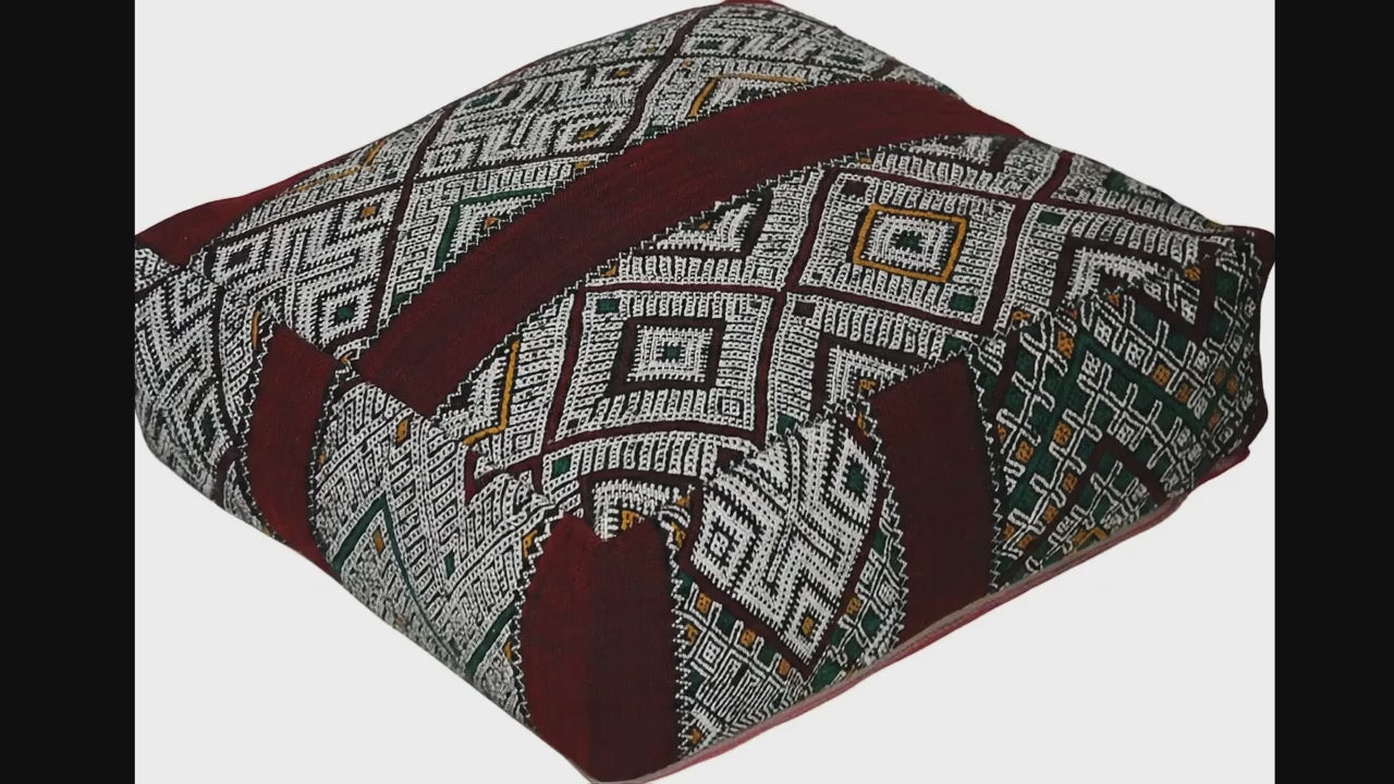 Video of vintage Moroccan kilim pouf burgundy multi showing texture and Berber details 